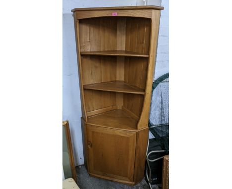 A vintage Ercol blonde elm corner cabinet having open shelves above a cupboard door, 179.5h x 77.5w, Location: 