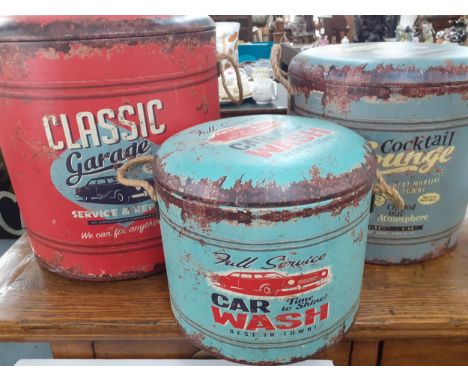 A group of three modern printed leather effect storage bins with cushioned seat lids and side rope twist handles decorated in