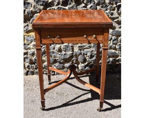 An Edwardian satinwood envelope card table by Maple &amp; Co, the square top with each flap string inlaid with scroll detail,