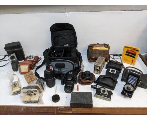 A mixed lot of vintage film cameras to include a Canon EO5 with lens and accessories, and others 