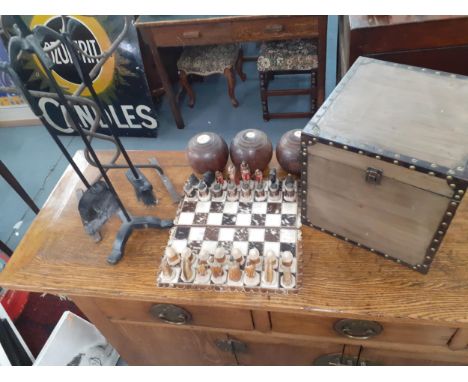 An Argentinian pony skin chess board together with resin American Indian pieces, three vintage lawn bowls to include two Tayl