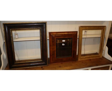 A walnut and parcel-gilt picture frame, a giltwood and gesso picture frame and a laburnum oyster veneered cushion frame, 45 x