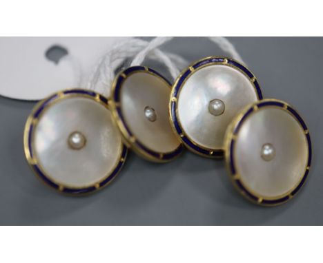 A pair of 18ct, mother of pearl seed pearl and blue enamel set disc cufflinks, diameter 14mm, gross 8.5 grams.CONDITION: Some