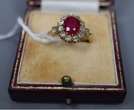 An early 20th century 18ct gold, synthetic? ruby and old round cut diamond set oval cluster ring, size N, gross 5 grams.CONDI