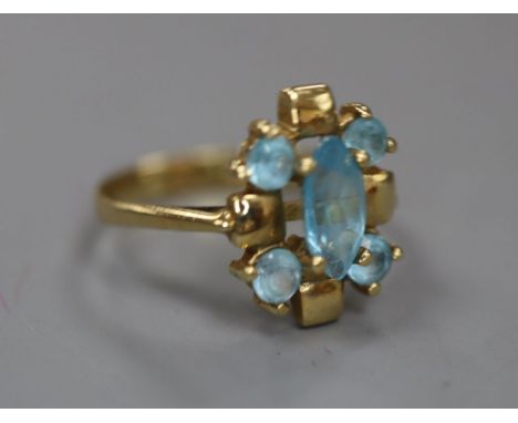 A modern 585 and blue topaz cluster dress ring, size J/K, gross 2.8 grams.