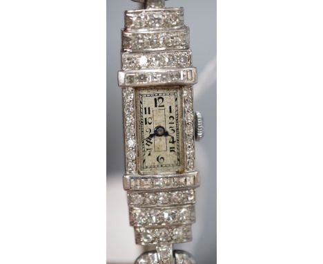 A lady's Art Deco white metal (stamped platinum) and diamond set manual wind cocktail watch, with fabric strap, 16.7cm, gross