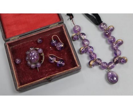 A Victorian amethyst bead and black sash necklace, (quartz section 21cm) and a similar brooch and pair of earrings (a.f.).