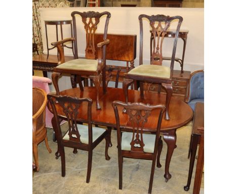 An early 20th century Chippendale revival mahogany dining suite comprising extending dining table and six chairs (one with ar