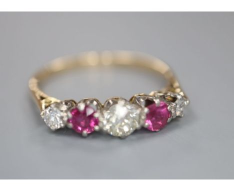 An early 20th century yellow metal and plat, three stone ruby and two stone diamond set half hoop ring, size Q, gross 2 grams