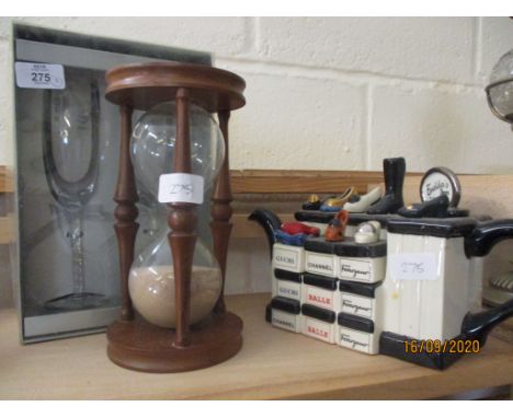 TWO COMEMORATIVE CHAMPAIGNE GLASSES TOGETHER WITH A WOODEN AND GLASS SAND TIMER AND FURTHER DECORATIVE TEAPOT 