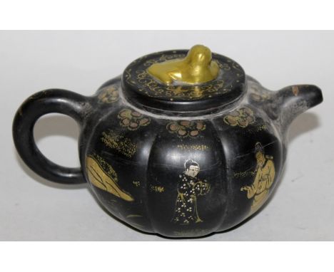 AN UNUSUAL CHINESE YIXING POTTERY TEAPOT & COVER, with silvered and gilded decoration on a black ground, the base with a moul