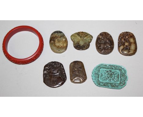 A GROUP OF SIX CHINESE JADE-LIKE PENDANTS, the largest 2in x 1.7in; a turquoise-coloured pendant, 2.6in x 1.8in; and a cinnab