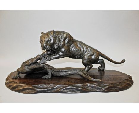 A GOOD QUALITY SIGNED JAPANESE MEIJI PERIOD BRONZE SECTIONAL GROUP OF A TIGER ATTACKING A CROCODILE, together with a wood bas