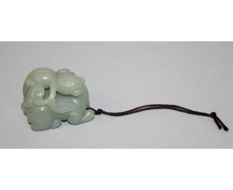A SMALL CELADON JADE-LIKE CARVING OF TWO CHILONG, clasping fronds of lingzhi in their mouths, 1.6in long & 1.3in high.