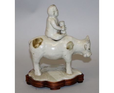 A CHINESE GLAZED POTTERY JOSS STICK HOLDER, possibly Ming Dynasty, in the form of a boy seated on the back of a water buffalo
