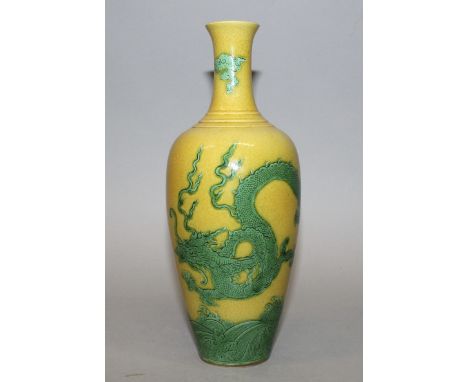 A CHINESE YELLOW & GREEN ENAMELLED PORCELAIN DRAGON VASE, decorated with a dragon and with flame and cloud scrolls above wave