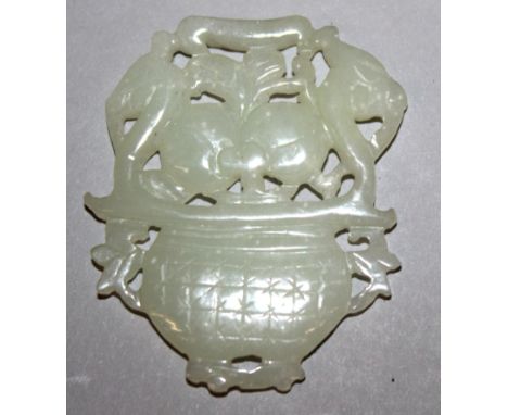 A SMALL CHINESE CELADON JADE PIERCED CARVING, in the form of a basket of peach with dragon handles, 1.9in high x 1.5in wide.