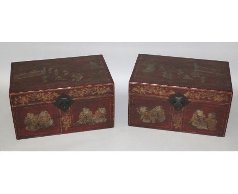 A LARGE PAIR OF EARLY 20TH CENTURY CHINESE LACQUERED WOOD RED GROUND RECTANGULAR CHESTS, each hinged cover decorated with a s