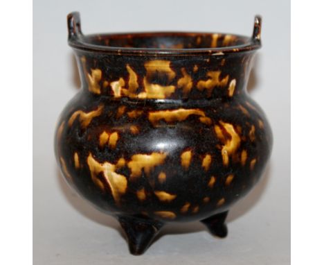 A CHINESE CIZHOU CERAMIC TRIPOD CENSER, with short double upright lug handles, the lustrous dark brown glaze with irregular b