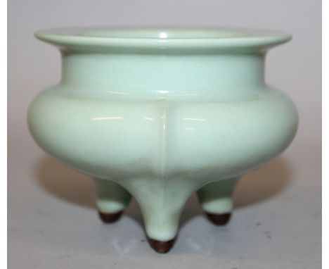 A CHINESE CELADON PORCELAIN TRIPOD CENSER, 4.1in diameter at rim & 3.25in high.