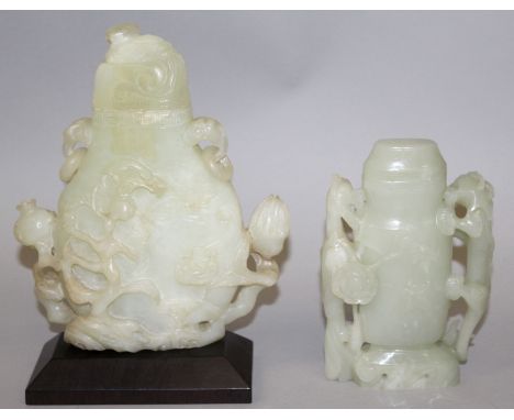 TWO CHINESE JADE-LIKE VASES & COVERS, one with a fitted hardwood stand, the vases themselves 4.9in high & 7.4in high overall.