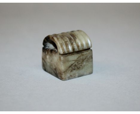AN UNUSUAL BROWN JADE SEAL, of square-section with a grooved semi-circular top, 0.9in square & 1.1in high.