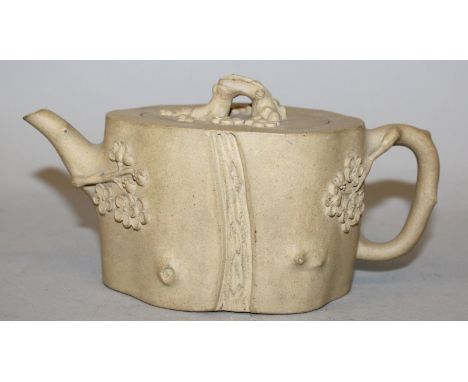 A CHINESE YIXING MOULDED POTTERY TEAPOT & COVER, the pottery of beige colour, the sides of the bark-form body moulded in reli