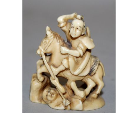 A 19TH/20TH CENTURY SIGNED JAPANESE IVORY NETSUKE, carved in the form of a mounted samurai spearing and trampling an opponent