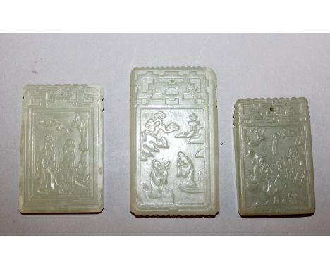 A GROUP OF THREE CHINESE CELADON JADE-LIKE PENDANTS, decorated with sages and calligraphy, various sizes, the largest 2.8in x