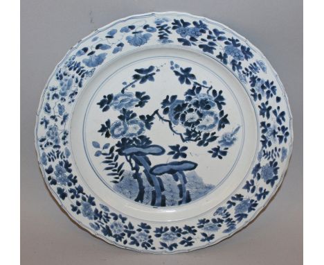 A GOOD CHINESE KANGXI MARK & PERIOD BLUE & WHITE PORCELAIN CHARGER, circa 1700, painted to its centre with a blossoming bough