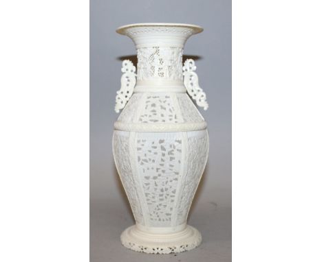 A GOOD 19TH CENTURY CHINESE CANTON IVORY VASE, of sectional construction on a splayed foot, the sides with pierced panels of 