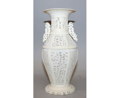 A GOOD 19TH CENTURY CHINESE CANTON IVORY VASE, of sectional construction on a splayed foot, the sides with pierced panels of 