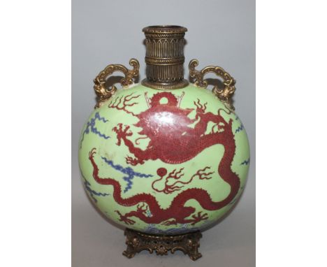 AN UNUSUAL CHINESE ORMOLU & PORCELAIN LIME-GREEN GROUND MOON FLASK, each side decorated in underglaze-blue and copper red wit