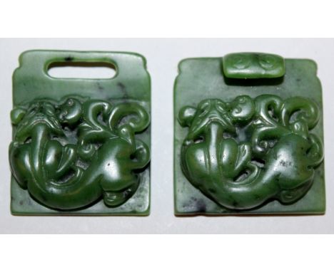 A CHINESE SPINACH GREEN JADE-LIKE TWO SECTION BUCKLE, each section with a chilong in relief, 3.4in wide when joined together.