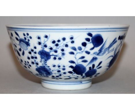 A 19TH CENTURY CHINESE BLUE & WHITE PORCELAIN BOWL, the sides painted with peach, pomegranate, peony and blossoms, the base w