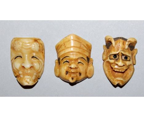 THREE SMALL 19TH/20TH CENTURY SIGNED JAPANESE IVORY KABUKI MASK NETSUKE, some of their features stained, each 1in high. (3)