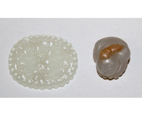 A SMALL CHINESE PIERCED JADE-LIKE OVAL PLAQUE, 1.75in wide x 1.5in; together with a small agate-like model of a boy, 1in long