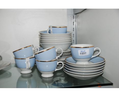 A Doulton part Dinner service in pale blue and white with gilt rim including six cups and saucers and fruit dishes and four e