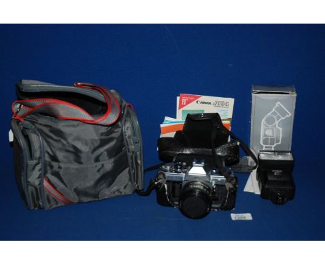A Canon AE-1 35mm SLR Camera with Canon FD 50mm f/1.8 lens and a Cobra MD210 flashgun.