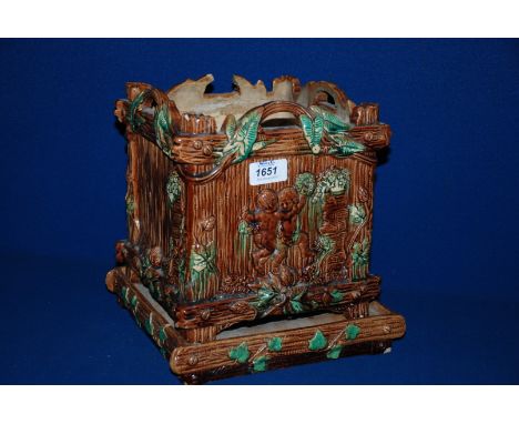 A Majolica Planter on stand, in the form of a square rustic basket decorated with ivy, hops and cherubs.  10'' tall