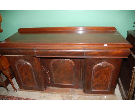 A Victorian Mahogany three door Sideboard, having moulded edge top, three curved front frieze drawers, over recessed single a