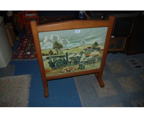 An Oak framed Fire Screen with tapestry panel of a Harvest scene.