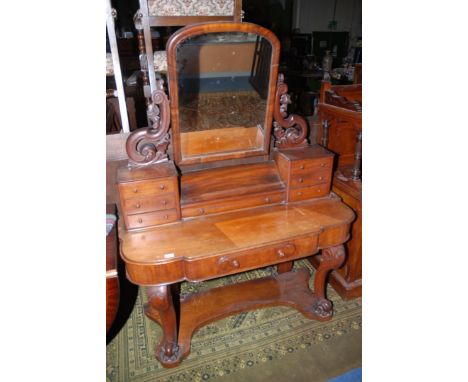 A Victorian Mahogany Duchess Dressing Table, having arch top mirror in ornate fret cut, carved and pierced floral supports, s