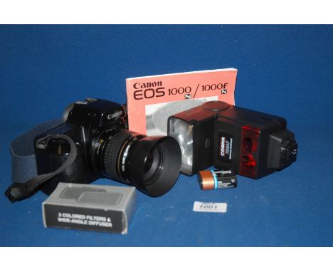 A Canon E0s 1000F  35mm Auto focus SLR Camera with 35 - 80 mm ultrasonic zoom lens.  Complete with instruction manual, strap 