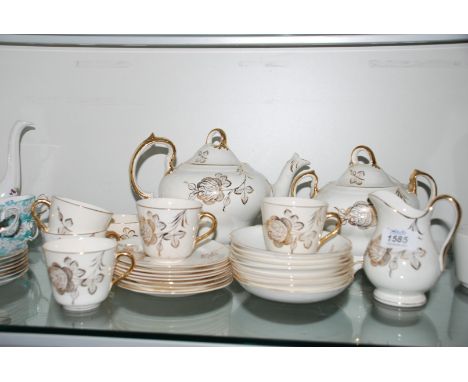 A pretty Victorian part Teaset comprising six Cups and saucers and tea plates, Teapot, lidded Sucrier, Milk Jug, cream ground