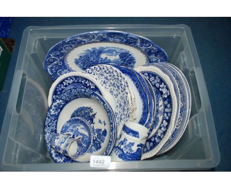 A quantity of blue and white including dinner plates, cake plates, milk jug, cups and saucers, etc.