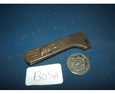 A miniature adjustable Spanner, 83mm. long