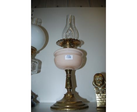 A Brass Oil Lamp with pink reservoir, glass chimney 