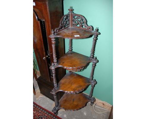 A superb early 19th c. four tier Walnut corner Wotnot, having pierced fret cut gallery top with finials, the four graduated w