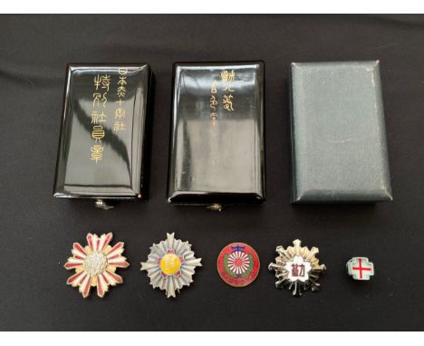 Japanese Patriotic enamel badges and three empty medal boxes. 